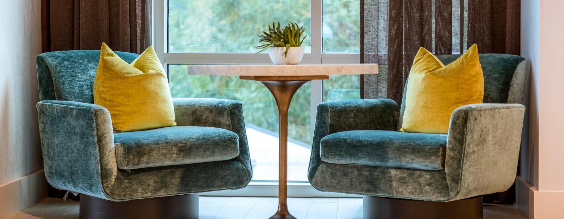 a couple of chairs and a table in front of a window